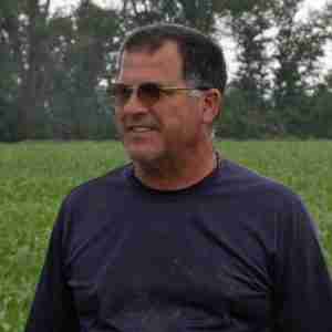 Gentleman named Dennis McKay from Owensboro, Kentucky standing on his farm.